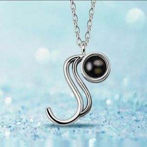 Letter necklace with pearl that says, "I love you"